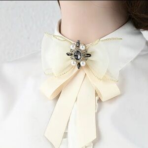 Chic Cream Bow Brooch with Pearl and Gem Accents